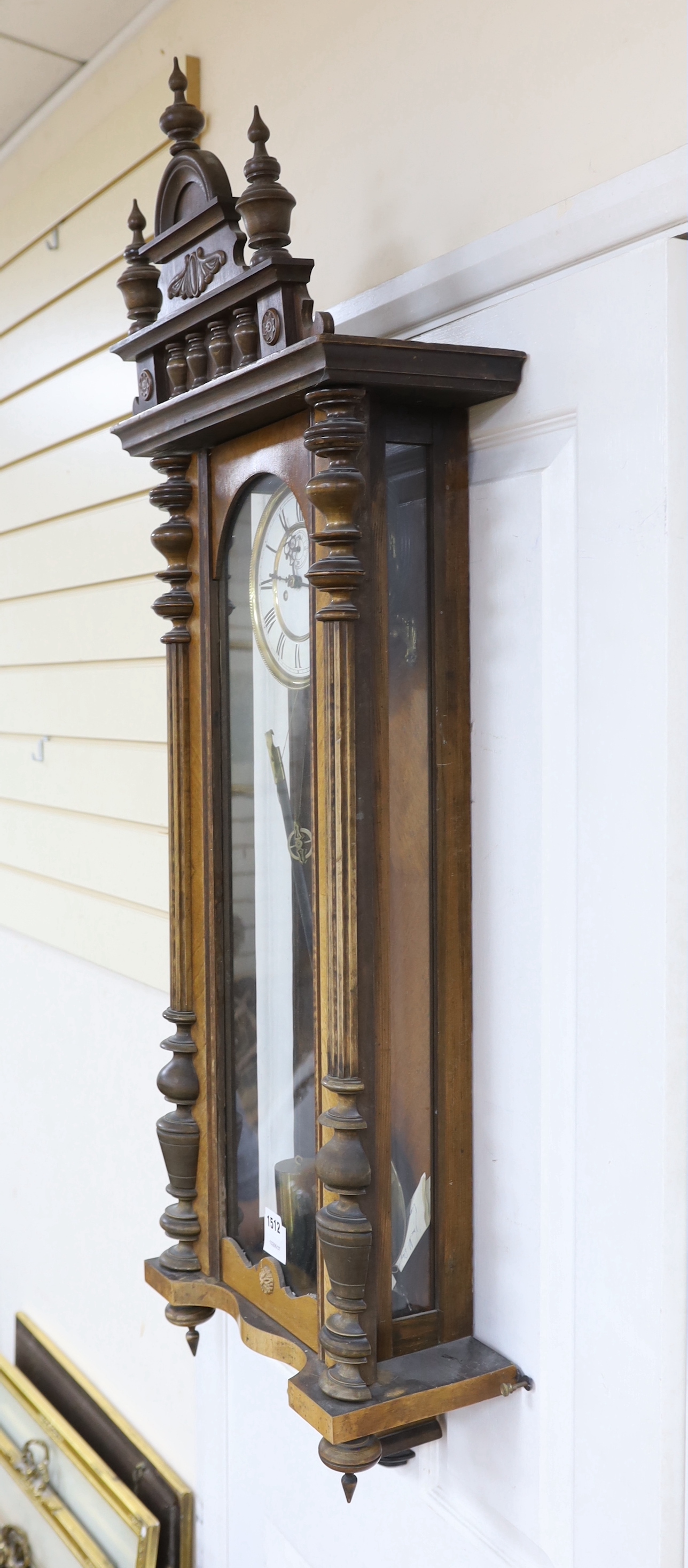 A carved walnut Vienna wall regulator with enamel dial, 125cm high